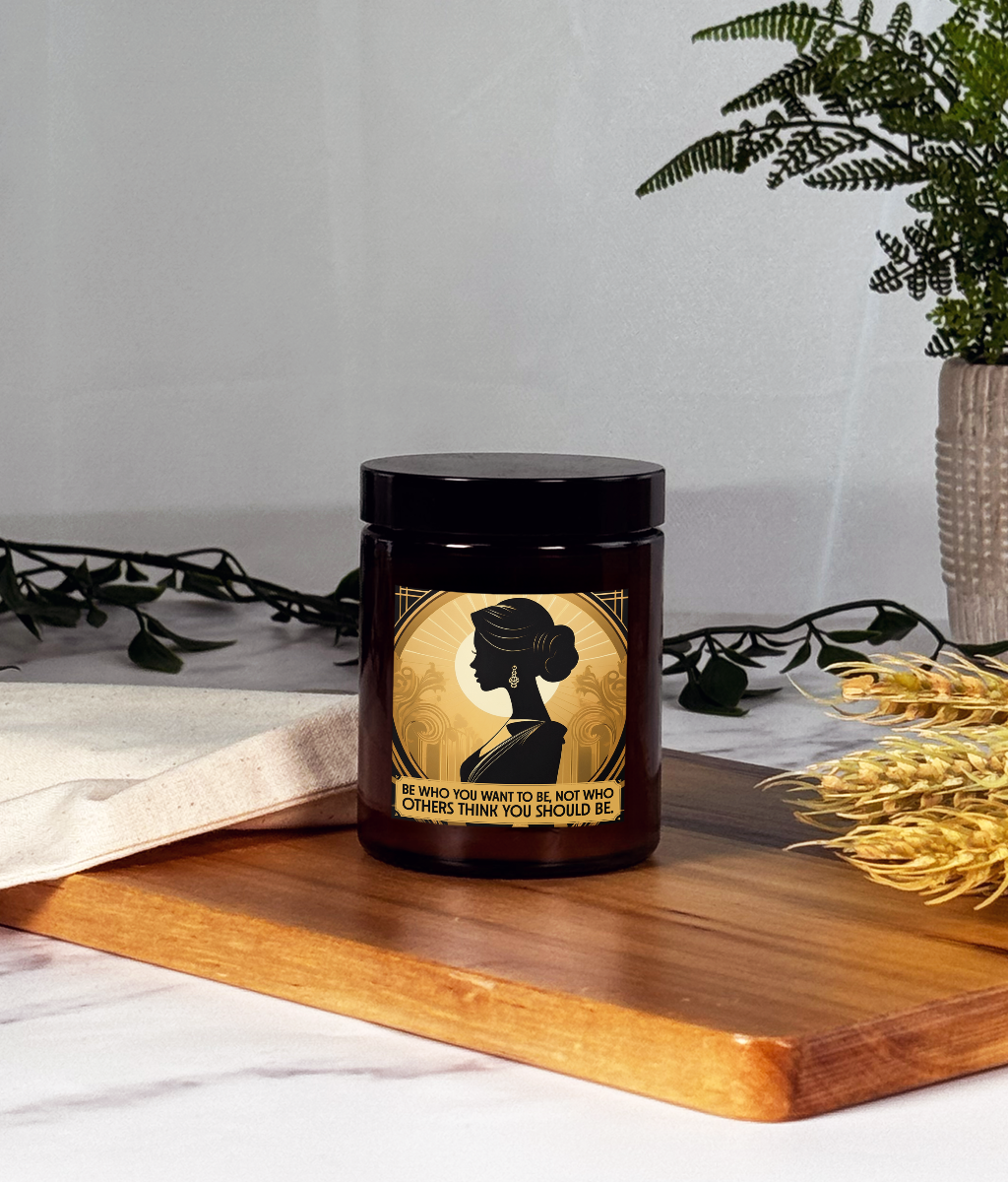 Candle with a decorative label featuring a silhouette on a wooden surface.