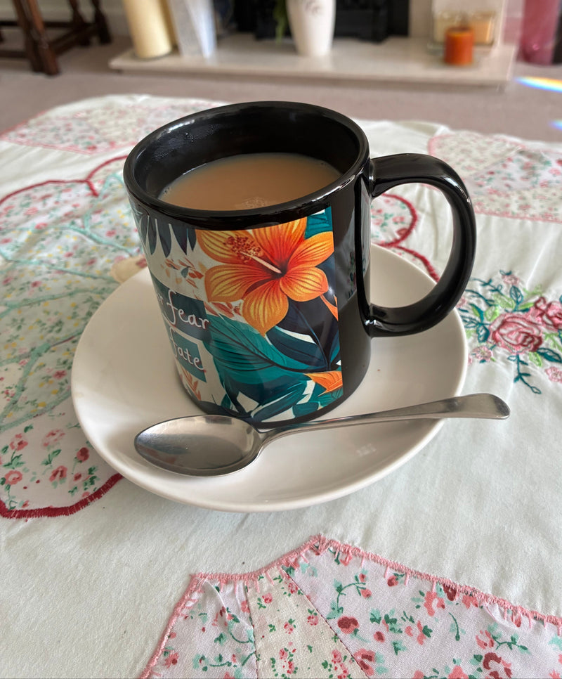 colourful mug on a white saucer 