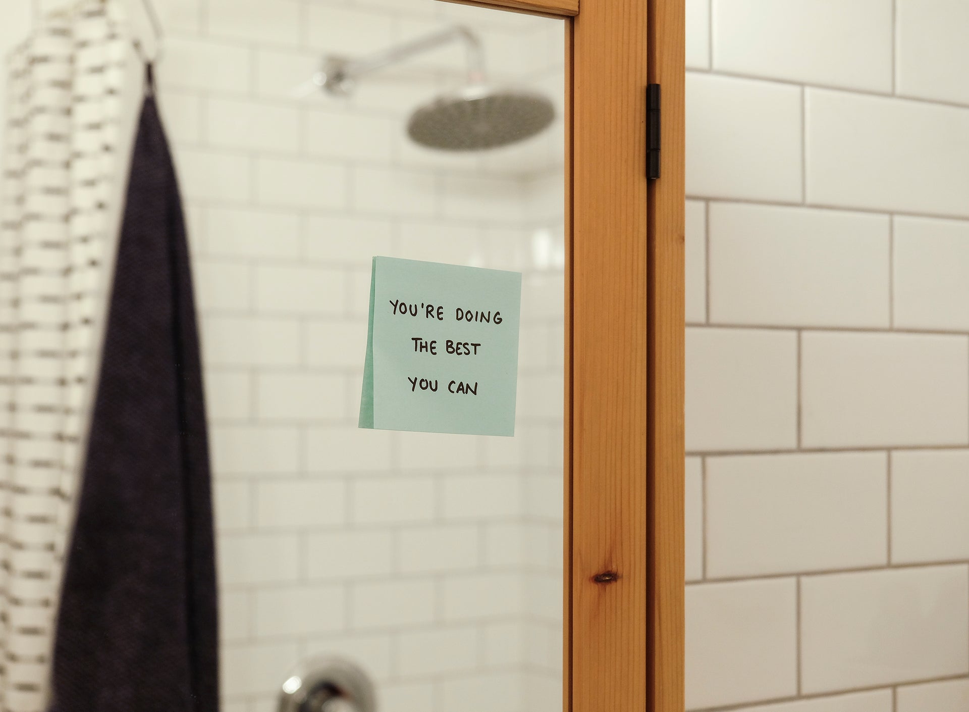 picture of a shower room with post-it note  saying Youre doing the best you can