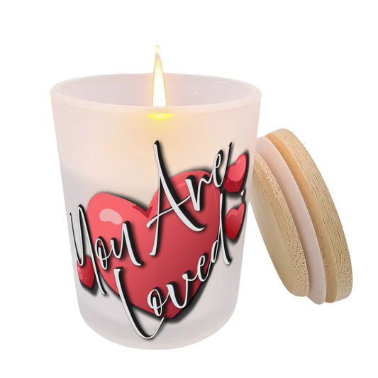 Candle with a red heart and 'You Are Loved' text on a white background